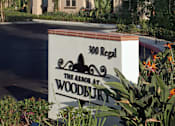 Thumbnail 73 of 117 - A sign for The Abode at Woodbury sits in front of a house.