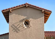 Thumbnail 65 of 117 - A building with a beige facade and a red tile roof has a large arched doorway.