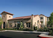 Thumbnail 76 of 117 - A building with a red tile roof and a parking lot in front.