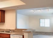 Thumbnail 116 of 117 - A kitchen with a white dishwasher and wooden cabinets.