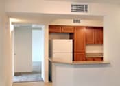 Thumbnail 111 of 117 - A kitchen with white walls and a white refrigerator.