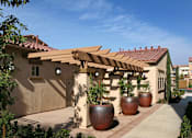 Thumbnail 37 of 117 - A house with a red tile roof and a wooden pergola.