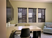 Thumbnail 49 of 117 - A conference room with a table, chairs, and a couch.