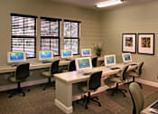 Thumbnail 105 of 117 - A room with a row of computers on desks.