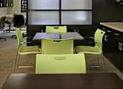 Thumbnail 47 of 117 - A conference room with a long table and chairs.