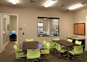 Thumbnail 110 of 117 - A conference room with a table and chairs.