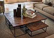 Thumbnail 42 of 117 - A coffee table with a stack of books and vases on top.