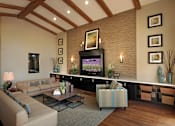 Thumbnail 104 of 117 - A living room with a flat screen TV and a couch.