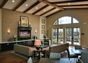 Thumbnail 32 of 117 - A living room with a fireplace and a painting on the wall.