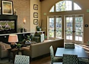 Thumbnail 22 of 117 - A living room with a fireplace and a painting on the wall.