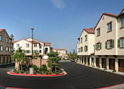 Thumbnail 12 of 117 - A row of houses with a red brick walkway in front.