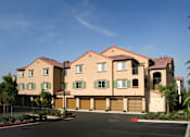 Thumbnail 15 of 117 - A large, multi-story building with a red roof and a driveway in front.