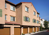 Thumbnail 4 of 117 - A row of houses with brown garage doors.