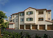 Thumbnail 6 of 117 - A large two story building with a red tile roof and a garage door.