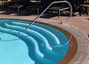 Thumbnail 16 of 45 - A pool with a metal ladder.