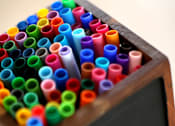 Thumbnail 19 of 45 - A box of colorful markers with a blackboard that says "markers".