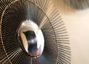 Thumbnail 20 of 45 - A close up of a metallic fan blade with a reflective surface.