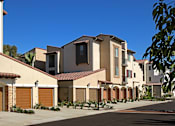 Thumbnail 31 of 45 - A row of houses with brown garage doors.