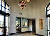 Thumbnail 35 of 45 - A hallway with a circular stone floor and a hanging light fixture.