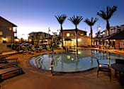 Thumbnail 37 of 45 - A pool surrounded by palm trees and lounge chairs.