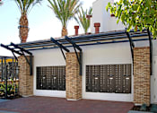 Thumbnail 44 of 45 - A house with a black gate and a black roof.