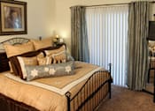 Thumbnail 15 of 126 - A bedroom with a large bed and a painting on the wall.