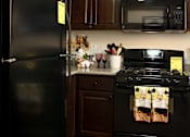 Thumbnail 30 of 126 - A black refrigerator with a yellow sticker on it.
