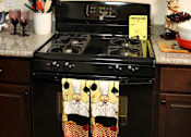 Thumbnail 26 of 126 - A black stove with a pot on it in a kitchen.