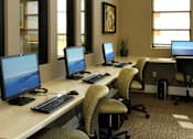 Thumbnail 21 of 126 - A row of computers are on desks in an office.