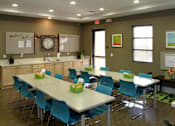 Thumbnail 20 of 126 - A conference room with a long table and chairs.