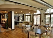 Thumbnail 123 of 126 - A modern dining room with a curved table and chairs.