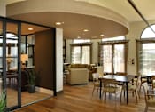 Thumbnail 126 of 126 - A modern living room with a curved ceiling and a glass door.