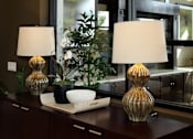 Thumbnail 124 of 126 - Two table lamps with white shades and two glass vases on a wooden table.
