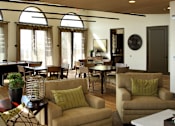 Thumbnail 109 of 126 - A living room with a white couch and a white coffee table.