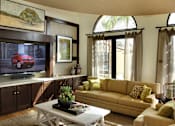 Thumbnail 107 of 126 - A living room with a red car on the television.