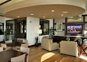 Thumbnail 113 of 126 - A modern living room with a curved ceiling and a flat screen TV.