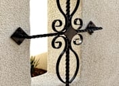 Thumbnail 104 of 126 - A black wrought iron window frame with a decorative design.
