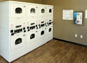 Thumbnail 120 of 126 - A row of washing machines are lined up in a room.
