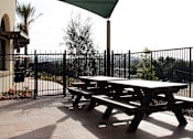 Thumbnail 94 of 126 - A picnic table is under a green shade sail.