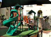 Thumbnail 92 of 126 - A green slide in a playground.