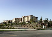 Thumbnail 102 of 126 - A row of houses on a hillside with a street in front.