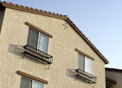 Thumbnail 100 of 126 - A building with two balconies and a cross symbol on the roof.