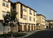 Thumbnail 76 of 126 - Apartment building with balconies and doors.