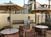 Thumbnail 60 of 126 - A patio with a table, chairs and umbrellas.