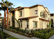 Thumbnail 63 of 126 - A row of houses with a sidewalk in front.