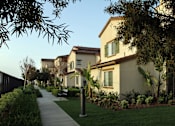 Thumbnail 54 of 126 - A residential street with houses and a sidewalk.