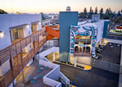 Thumbnail 4 of 11 - A building with a blue and white mural on the side.
