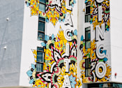 Thumbnail 2 of 17 - A building with a mural on the side of it.