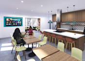 Thumbnail 10 of 17 - A woman is sitting at a table in a modern kitchen.