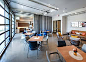 Thumbnail 14 of 102 - A modern dining area with a long table and chairs.